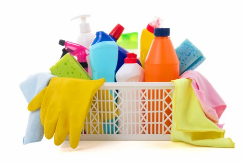 Cleaner using safe working practices in a tidy indoor environment