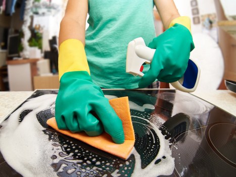 Cleaner in Fulham organizing home cleaning supplies